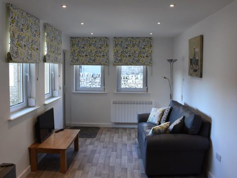 Comfortably furnished lounge inside a portable residential unit