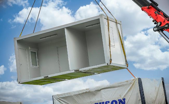 Strong steel-framed modular building being craned in to place